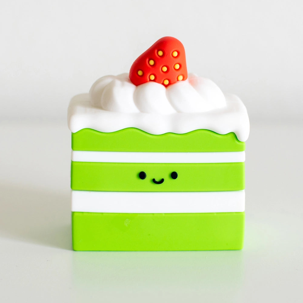 Cake-licious name stamp designed like a green and white layered cake with strawberry and icing on top